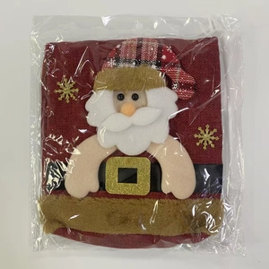 Detail of Christmas gift bag with Santa Claus applique and golden snowflake pattern