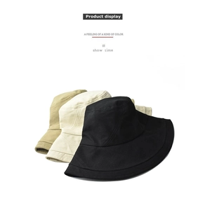 Three stacked cotton bucket hats in black, cream, and khaki with reinforced stitched brims