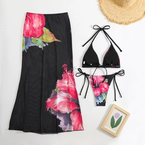 Detailed flat lay of a 3-piece floral bikini set with black mesh side-slit maxi skirt