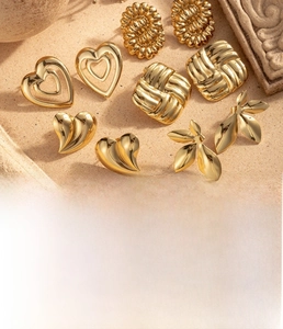 Macro shot of titanium steel gold heart earrings with vintage weave texture and metallic shine