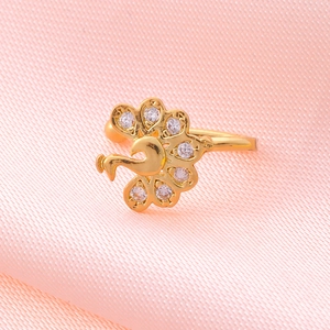 Macro shot of gold peacock non-pierced clip on nose ring with white zircon stones