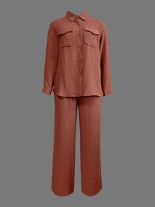 Detail of brick red textured fabric on women's long sleeve shirt and wide leg trousers set
