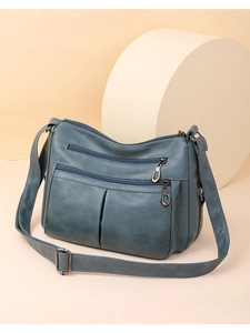 Close-up of litchi texture leather shoulder bag with multiple functional zippers