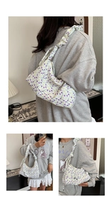 Floral shoulder bag featuring purple flower print and ruffled shoulder strap detail