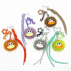 Cute fuzzy monster plush keychains in five colors with woven ropes and star charms