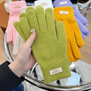 Thick knitted winter gloves in colorful candy tones with soft touch texture and ribbed cuffs