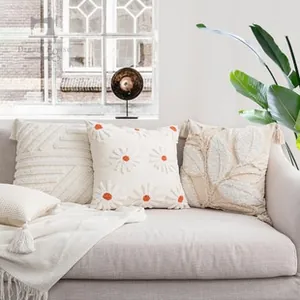 Detail of bohemian tufted pillowcases with daisy patterns and elegant tassel accents