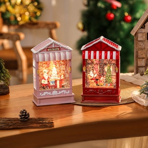 Cozy festive setting showing lighted pink cake shop and red Christmas tree music lanterns