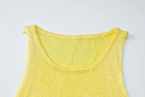 Detail of the crew neckline and fine knit texture on this bright yellow sleeveless top