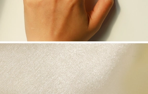 Detailed macro view of woven cream fabric texture on 18k gold plated angel ring