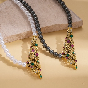 Vintage style faux pearl necklaces with ornate gold floral pendants and colorful rhinestones