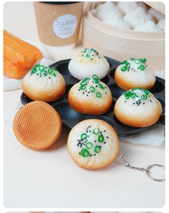 Realistic PVC pan-fried bun keychain with golden crust detail in a breakfast setting