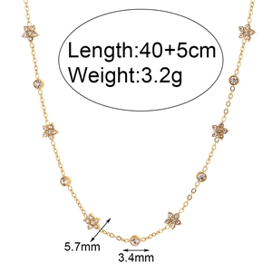 Gold chain necklace with floral charms and round zircons on a clean white background