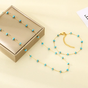 Detailed view of golden chain necklace and bracelet set with blue square turquoise beads