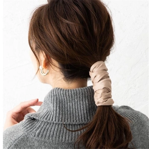 Japanese retro beige fabric hair tie shown on a low ponytail with grey knit sweater