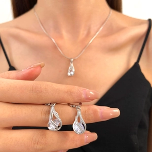 Vintage silver zircon jewelry set featuring teardrop pendant necklace and stud earrings