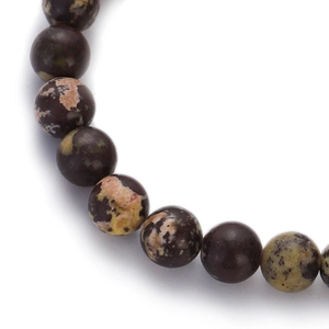 Macro shot of colorful leopard skin jasper beaded bracelet showing natural stone textures