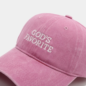Detail of embroidered GOD'S FAVORITE text on a rose pink brushed cotton baseball cap
