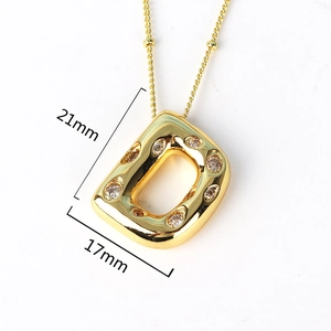 Detailed view of gold letter D pendant with white zircons showing 21mm by 17mm dimensions