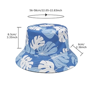 Blue double-sided bucket hat with white tropical leaf print and specific size measurements