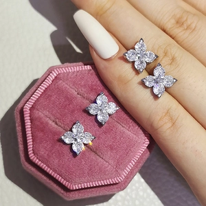 Macro shot of silver flower stud earrings with white zircons in a jewelry box