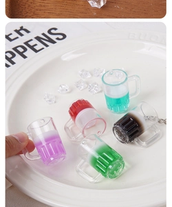 Détail de cinq mini pendentifs de chope de bière colorés avec mousse et faux glaçons