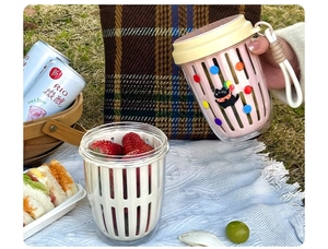 Pink portable salad cup with cat pattern in a picnic setting with double-layer design