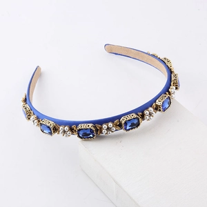 Detail of royal blue satin headband with rectangle blue rhinestones and pearl flower motifs