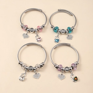 Detail view of steel wire charm bracelets with swan and heart crystal pendants