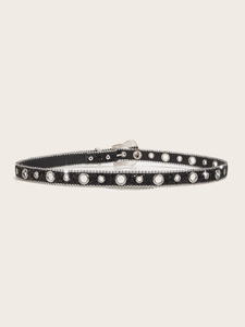 Detail of a thin black rhinestone belt with silver eyelets and sequin finish for women