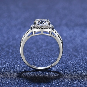 Macro detail of halo setting engagement ring with round zircon and paved band
