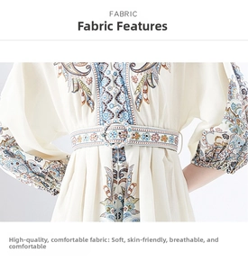 Detail of bohemian mini dress showing paisley embroidery on lantern sleeves and belted waist