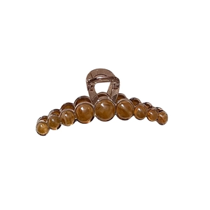 Elegant amber resin hair claw clip with polished beads decoration on white background
