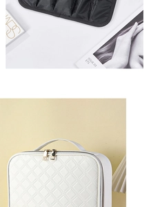 Detail of white quilted PU leather makeup case with gold zippers and organized interior