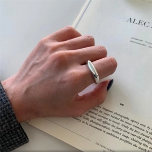 Minimalist silver 925 irregular ring with polished mirror finish worn on hand