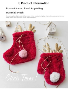 Close-up of festive red plush Christmas stocking and glove gift bags with gold antlers