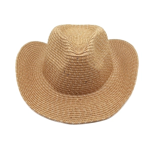 Détail du tissage de chapeau de cow-boy en paille marron avec fils blancs et sequins dorés