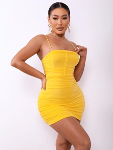 Detail of a sexy slim-fit yellow bodycon dress with spaghetti straps and pleated ruffles