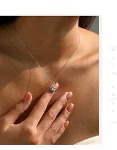 Detail of S925 silver octagonal necklace with large round-cut zircon on female model