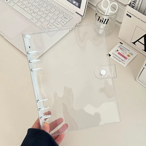 Close-up of clear PVC 6-ring binder cover with white binder clips and snap button