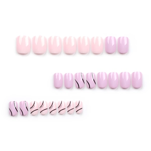 Short square press-on nails in light pink and purple with black wavy lines and silver glitter