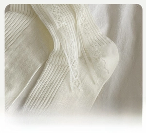 Close-up of cream Lolita socks with delicate floral lace trim and ribbed texture detail