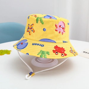 Detail of yellow cotton kids sun hat featuring ocean prints and adjustable wind cord