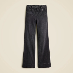 Detail shot of high-waisted black wide-leg jeans featuring front patch pockets and denim texture