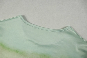 Close-up of the green gradient crew neckline and smooth fabric texture on the dress