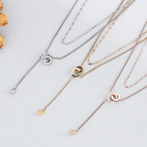 Double layer necklaces with sparkling interlocking rings and tassel charms in three metal tones
