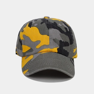 Detail view of reinforced stitching on curved brim of yellow camouflage baseball cap