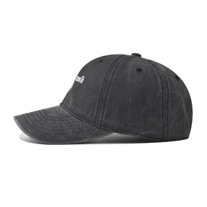 Close-up of side embroidery and washed canvas texture on the charcoal baseball cap