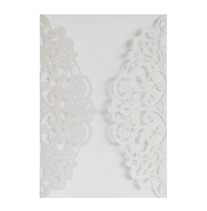 Macro detail of laser-cut glitter paper wedding invitation cover with floral patterns