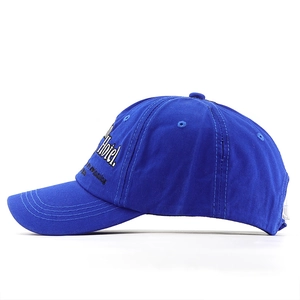 Detail of embroidered hotel lettering on a royal blue washed cotton baseball cap